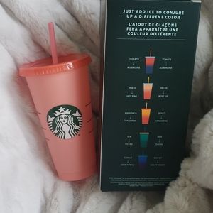 One peach colored changing starbucks cup